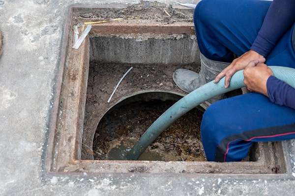 foul odors, slow drainage, and visible grease buildup are all signs that your grease trap needs pumping